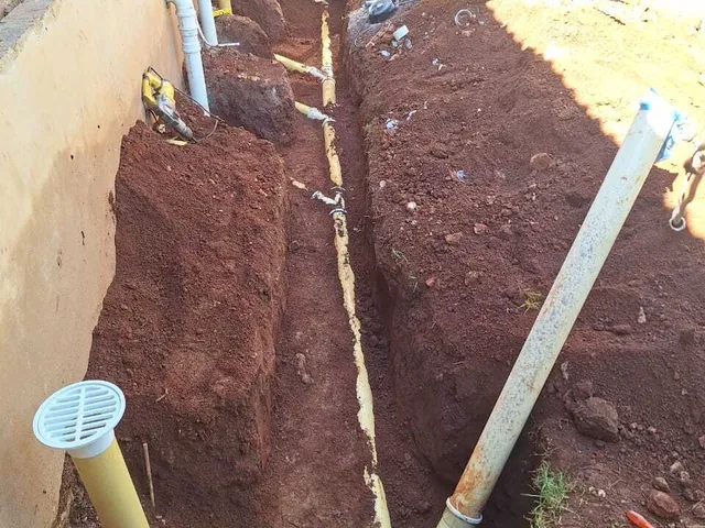 Drainage pipes being laid in a trench